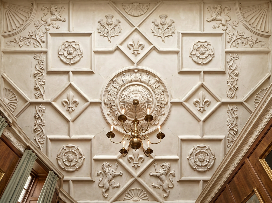 Plaster Ceiling scenic wallpaper mural on the feature wall of a Hollywood-Regency living room lounge_d95dc165 e18f 4616 a991 5d479faaf432, in a soft grey palette — The Wall Shawl.