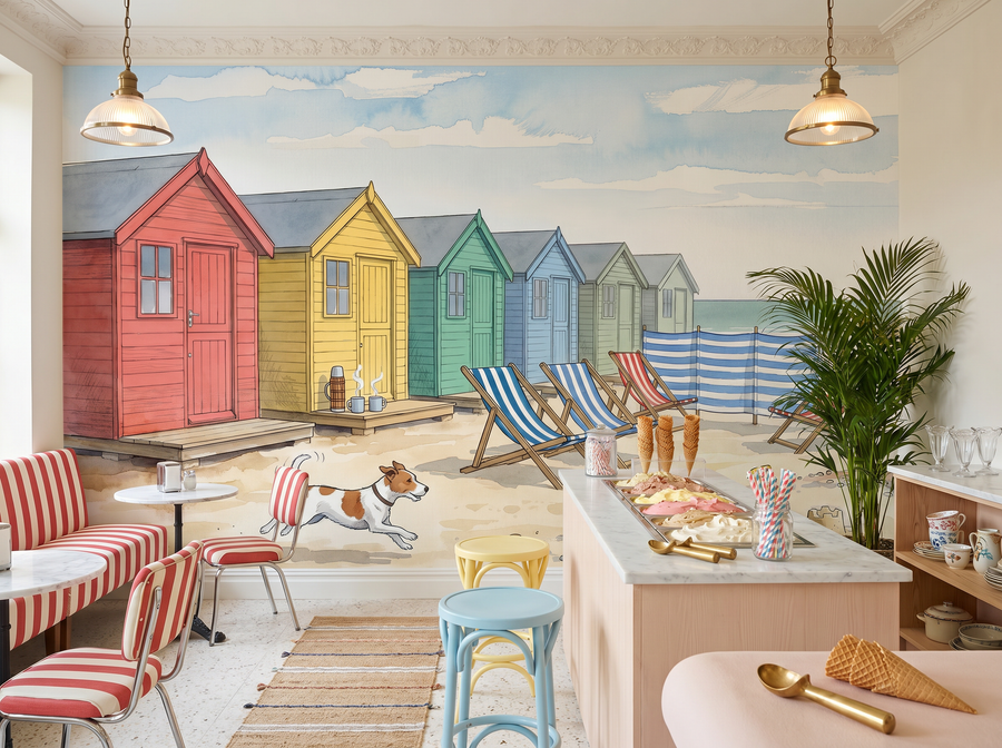 Beach Huts scenic wallpaper mural on the feature wall of a coastal bedroom, in a cool blue palette — The Wall Shawl.
